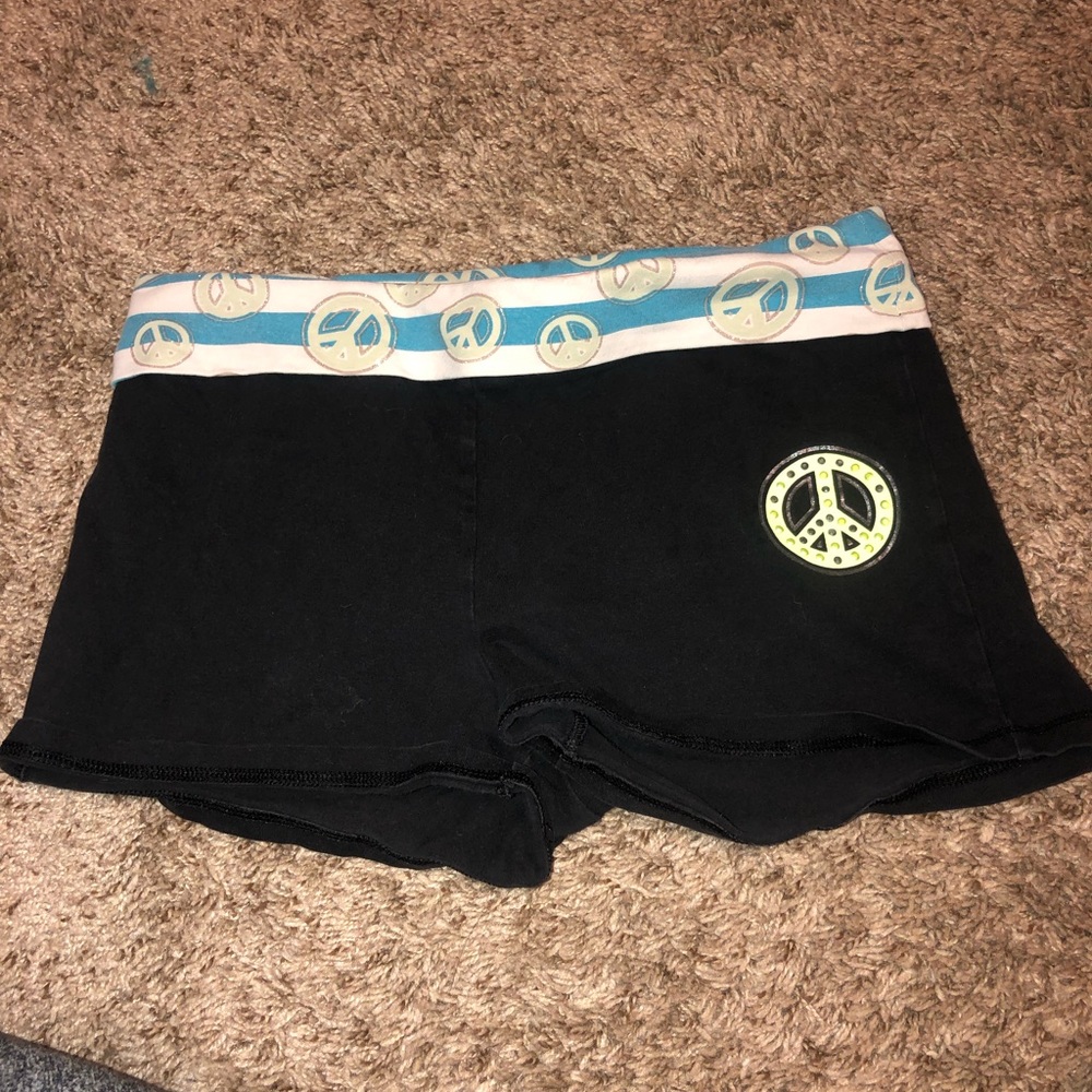 Black shorts with blue peace sign waist band